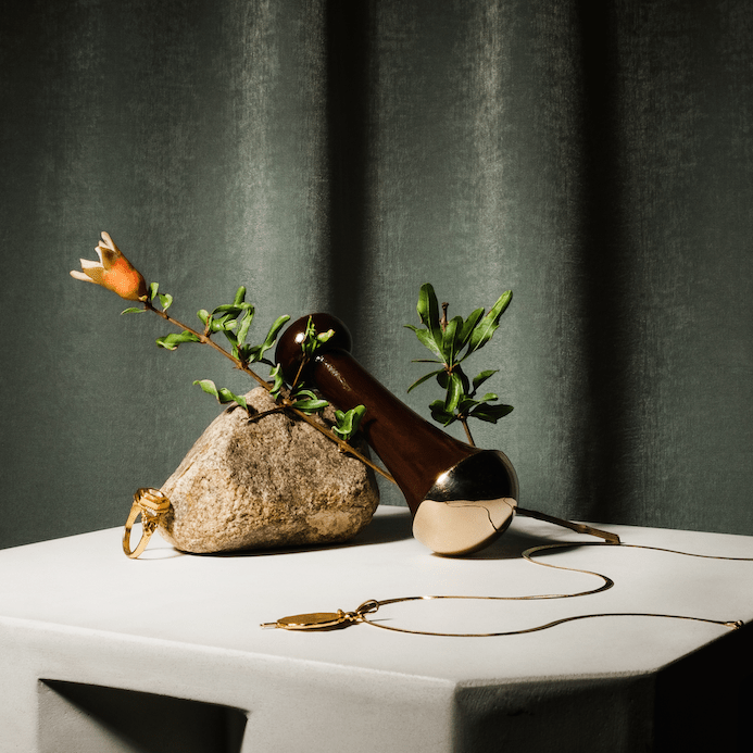 Ranavat Kansa wall on stone with branch on white table with gray green curtain