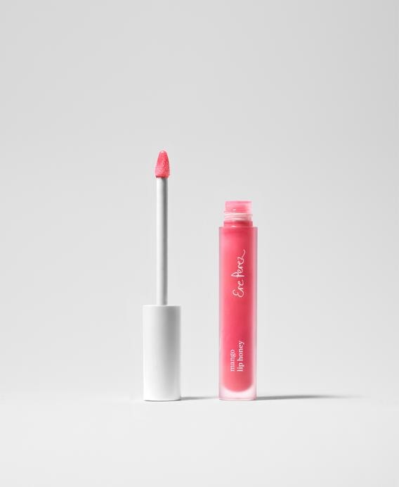 Ere Perez Mango Lip Honey Lipgloss i stands open against a white background.