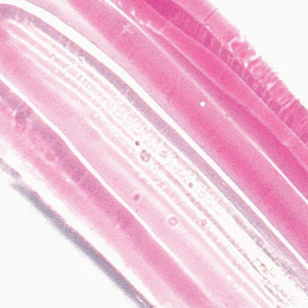 Color and texture example of the Ere Perez Mango Lip Honey lip gloss in the color Crush. North Glow