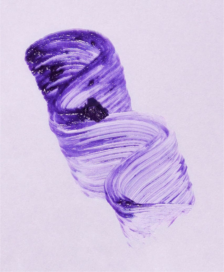 Color and texture example of Ere Perez Natural Almond Mascara in mauve on a white base.