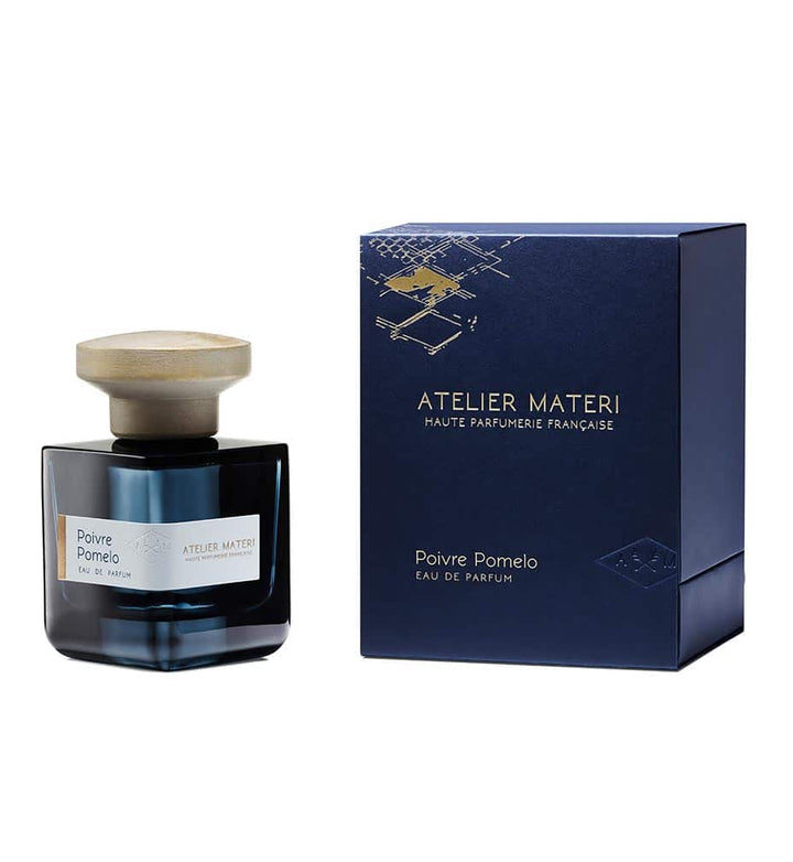 Dark blue glass bottle with gray lid and dark blue gift box "Poivre Pomelo" by Atelier Materi against a white background.