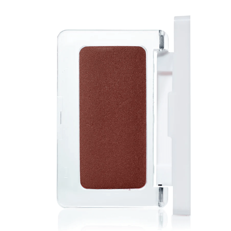 Open pressed blush tin from RMS Beauty against a white background.