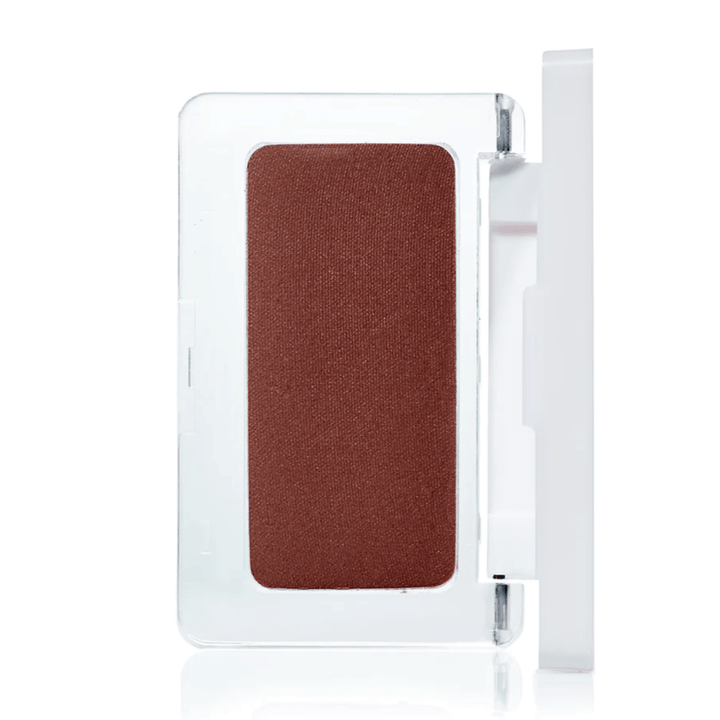 Open pressed blush tin from RMS Beauty against a white background.