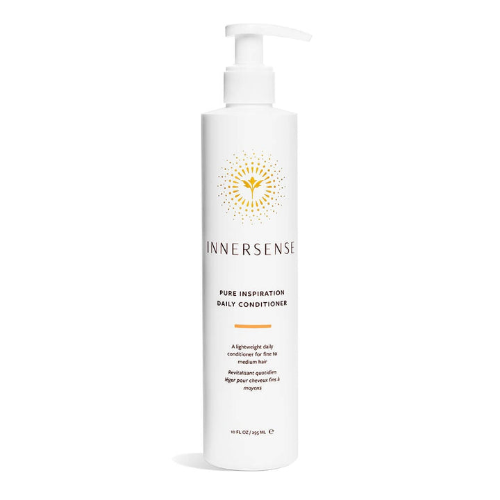 A pump bottle of Innersense Pure Inspiration Daily Conditioner stands against a white background.