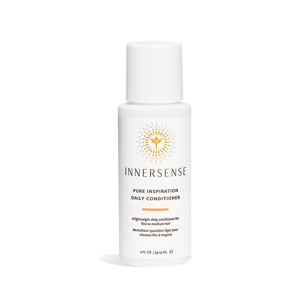 A pump bottle of Innersense Pure Inspiration Daily Conditioner in travel size stands against a white background. North Glow