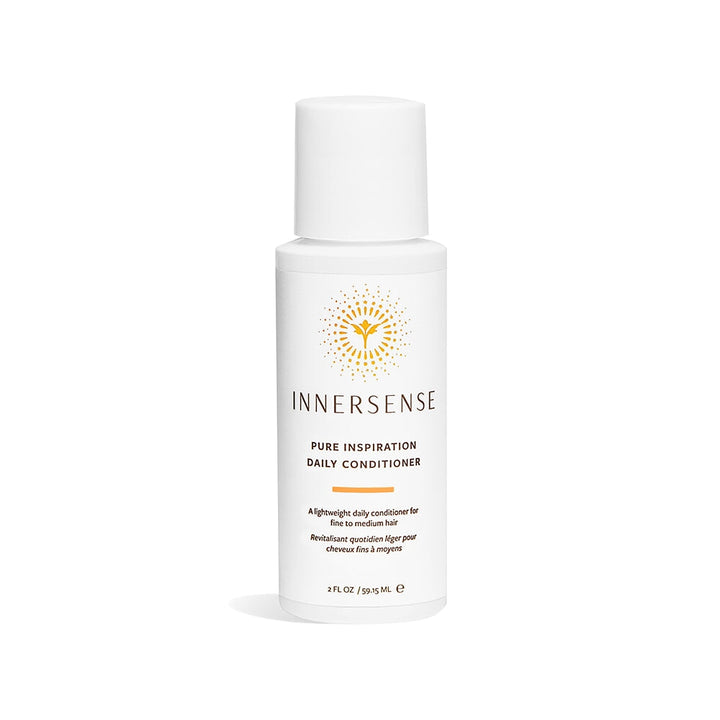 A pump bottle of Innersense Pure Inspiration Daily Conditioner in travel size stands against a white background.