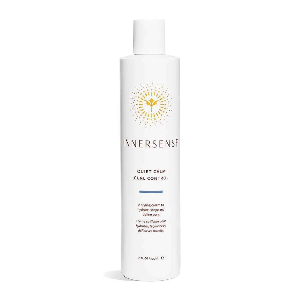 A bottle of Innersense Quiet Calm Curl Control stands against a white background. North Glow