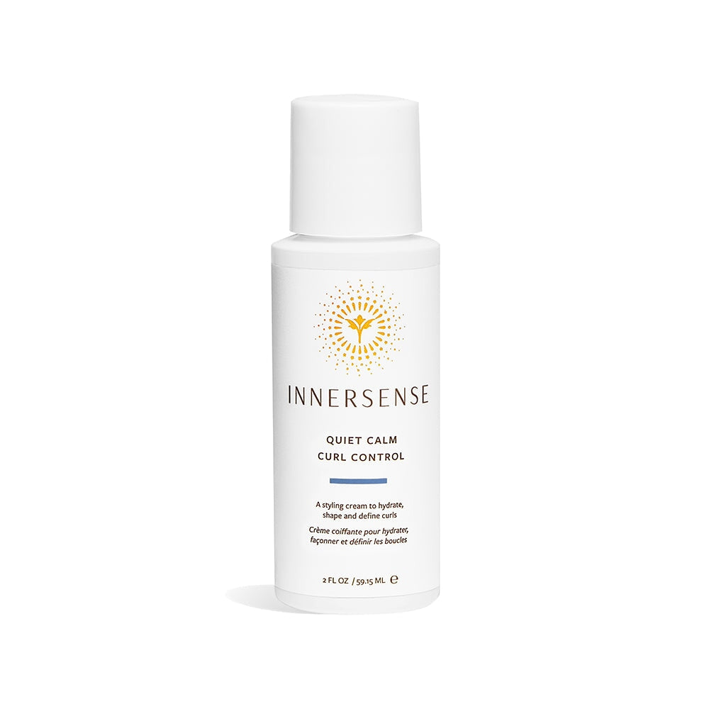 A travel-sized bottle of Innersense Quiet Calm Curl Control stands against a white background. North Glow