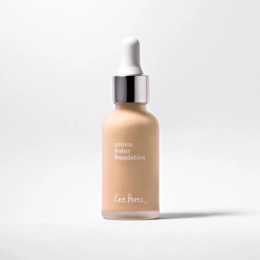 Glass bottle of Ere Perez Quinoa Foundation Haze against a white background. North Glow