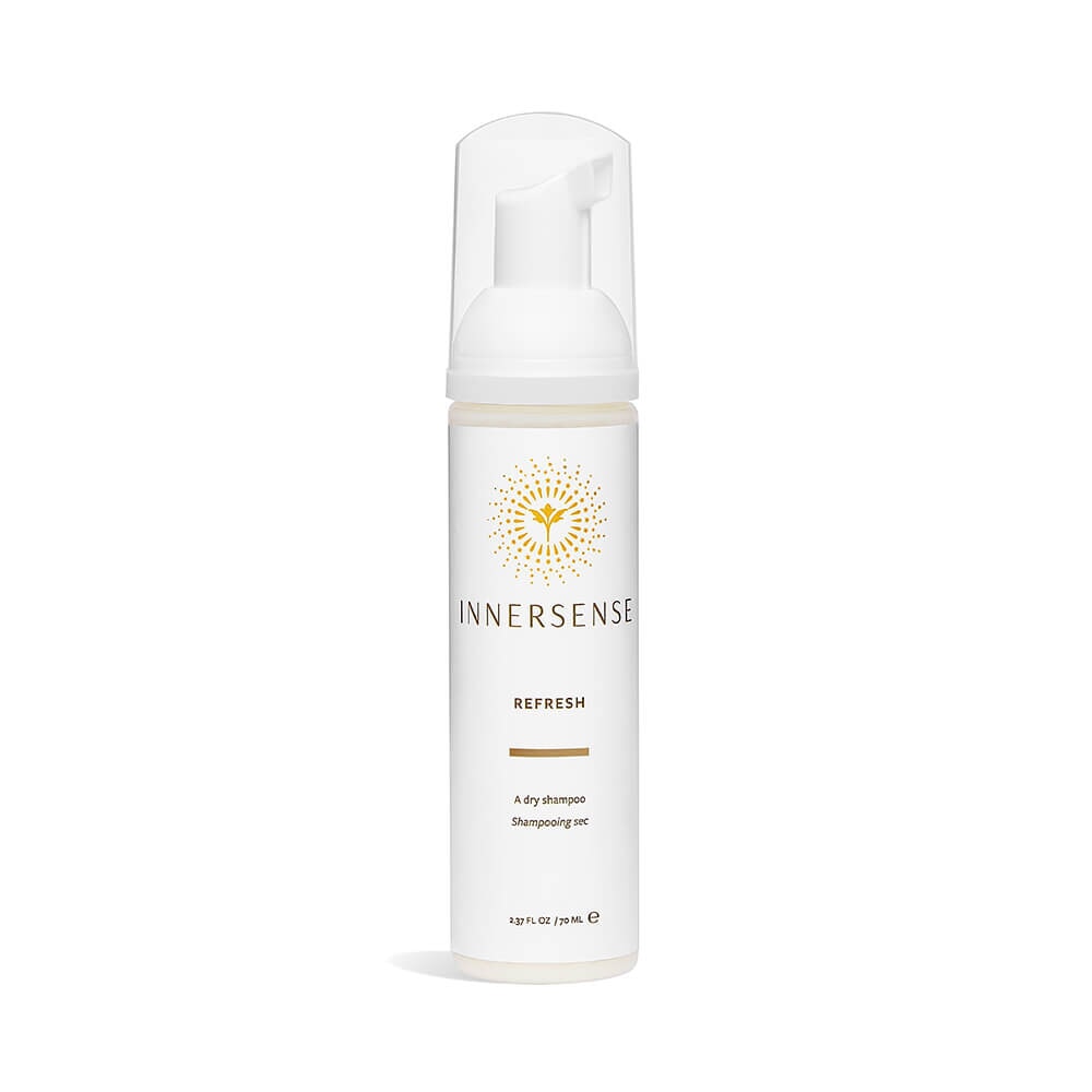 A pump bottle of Innersense Refresh stands in front of a white background. North Glow