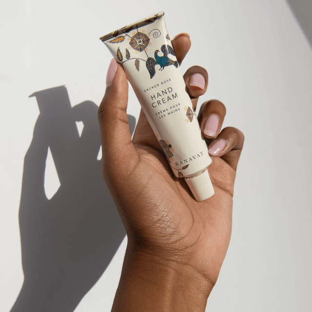 Ranavat Sacred Rose Hand Cream Tube is held against a white background
