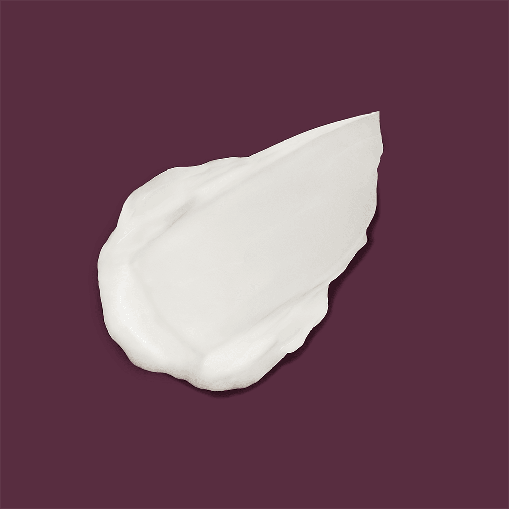 Texture example of Innersense Serenity Smoothing Cream on a burgundy background. North Glow